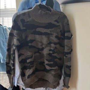 Gorgeous camo stretchy sweater . So stylish with a pair of your favorite jeans